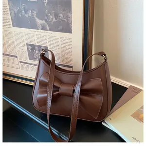 Brown PU leather underarm shoulder bag with chic bow knot design, elegant fashion accessory.