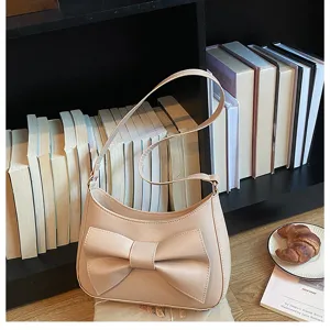 Chic beige shoulder bag with stylish bow accent, perfect for daily wear and versatile outfits.
