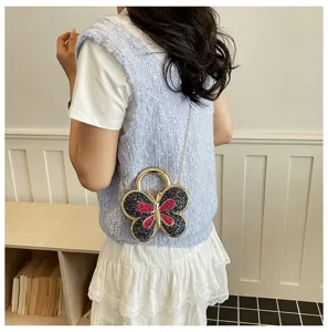 Stylish acrylic butterfly crossbody bag with glitter details and chic chain strap for women.
