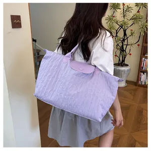 Detailed lifestyle view of the light purple pleated shoulder bag, casual commuting tote.