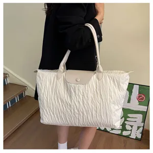 Details of the casual pleated tote bag showcasing large capacity and elegant shoulder strap.