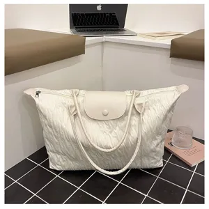 Detailed view of the large capacity casual travel shoulder bag with pleated design and leather flap.