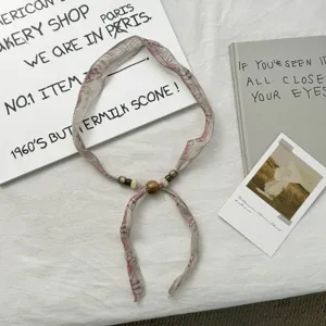 Details of Chinese retro ink floral beaded ribbon scarf, chic spring summer neck accessory.