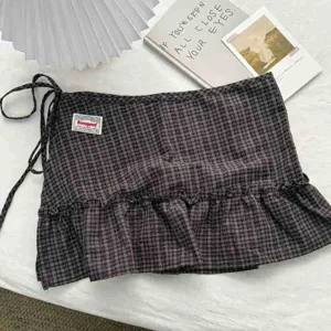 Brown plaid high-waisted ruffle mini skirt, vintage style layered wrap skirt detail.