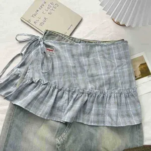 Details of the blue plaid ruffled layered skirt, featuring a delicate cake hem and side tie.