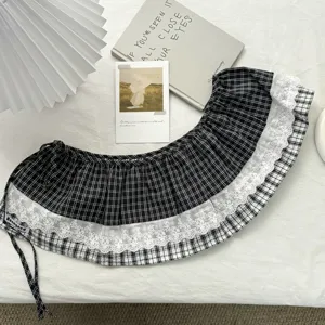 Detailed view of vintage black and white plaid skirt extender with delicate white lace trim.