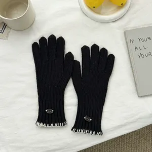 Women winter warm black knitted gloves with white contrast stitching detail for cycling.