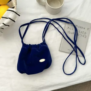Velvet bucket bag detail, vintage French style shoulder crossbody pouch for autumn and winter fashion.