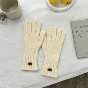 Detailed shot of Korean style solid color knit gloves for women, warm winter touch screen gloves.