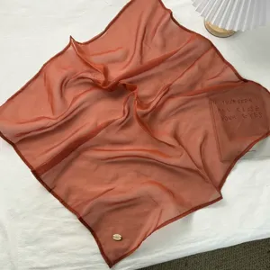 Gedetailleerd overzicht van de lichte terracotta Chiffon vierkante sjaal voor damesstijl.