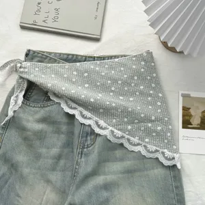 Detailed view of the French sweet lace plaid triangular scarf and denim pants, chic rustic style.