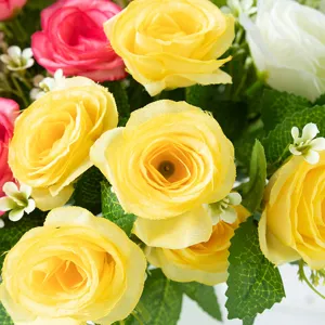 Artificial silk rose bouquet detail shot, vibrant yellow, pink, and white decorative flowers.
