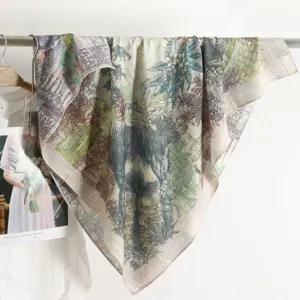 Detailed view of a vintage botanical print square scarf, draped elegantly on a metal bar.