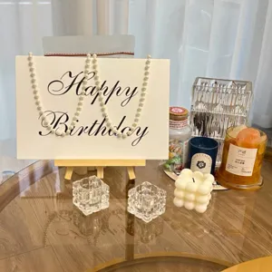Birthday card holder detail shot, acrylic or paper poster stand with party decor props for tabletop.