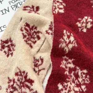 Detailed close-up of red Fair Isle jacquard knit scarf showing soft winter texture.