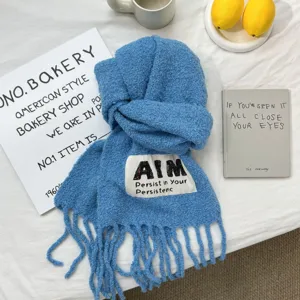 Blue textured fringe scarf with letter label detail, soft winter warm wrap shawl for women.