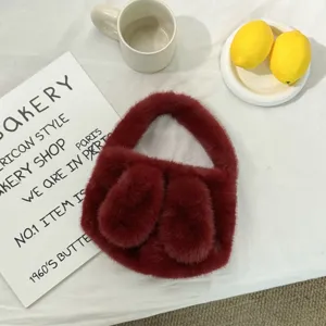 Cozy winter plush rabbit ear handbag detail, soft burgundy fuzzy fabric, cute mini purse.
