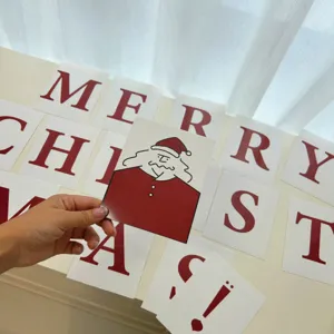 Detailed view of minimalist red and white Christmas letter cards and Santa Claus photo prop.