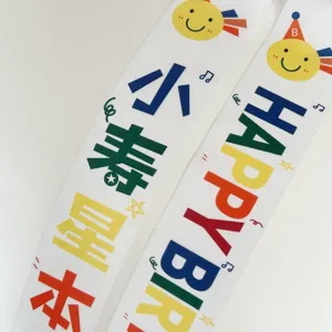 Birthday party sash detail shot, cute sun print and celebration text for kids celebration.