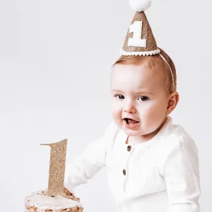 Detail view of Nordic minimalist burlap birthday hat with number one for baby party.