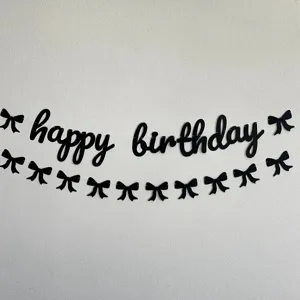 Black happy birthday letter banner with cute bow decorations for kids party decor!