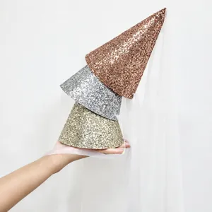 Details of sparkly cone party hats with white tulle veils in gold, silver and rose gold.