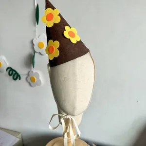 Brown felt flower party hat for baby birthday photography props and cute one year old celebrations.