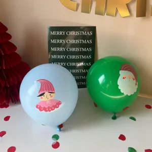 Detail view of 12-inch latex Christmas balloons featuring cute Santa and elf prints for party decor.