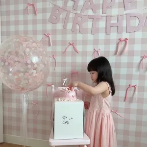 Pink bow birthday party decoration banner set with checkered background and balloons for kids party.