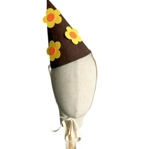 Felt birthday party hat for baby toddler brown cone hat with cute yellow flower decorations.