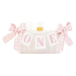 Pink gingham first birthday high chair banner with cute bows for baby party decorations.