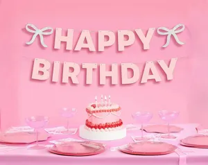 Pink birthday party banner bunting set with glitter letters and cute bows for celebration.