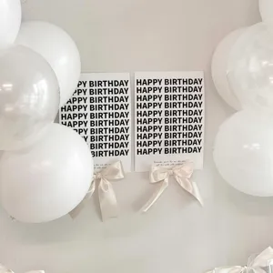 Ins style birthday party wall cards with white balloons and ribbon bow decorations for baby.