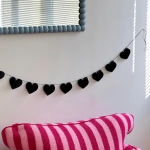 Black heart paper garland detail view shot for party room interior wall decoration setup