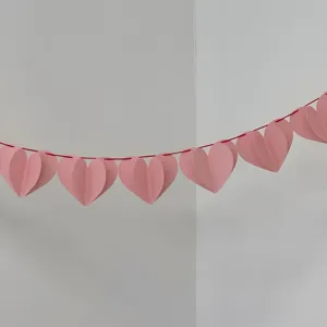 Pink paper heart garland detail, perfect for romantic party and birthday decorations indoor.