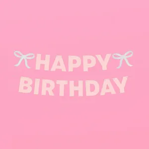 Detail of pink glitter Happy Birthday letter banner and bow decoration for party.