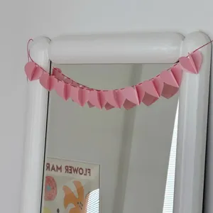 Pink 3D paper heart garland detail shot, perfect for romantic party and indoor decorations.