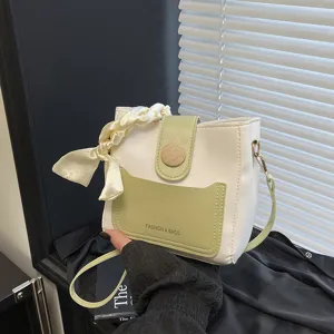 Stylish small bucket bag for women, chic two-tone design with handle scarf and crossbody.