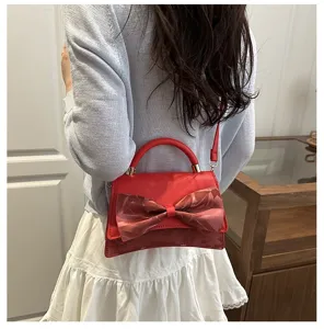 Stylish red women crossbody bag with elegant bow detail, perfect for summer casual daily wear.