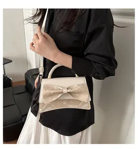 Stylish women's handbag with a large bow and asymmetric flap design, perfect for daily wear.