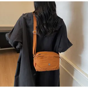 Detailed view of lightweight nylon crossbody bag in brown, casual daily shoulder bag for women.