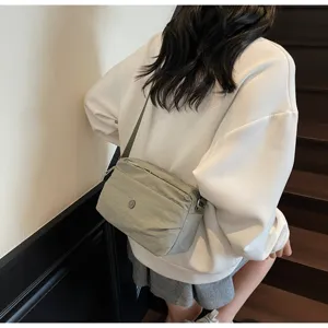 Detail view of the lightweight nylon crossbody bag worn by model, highlighting daily casual style.