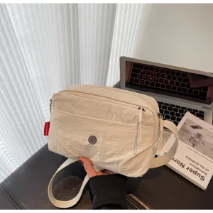 Minimalist nylon crossbody bag for women, lightweight casual shoulder bag with front pocket.