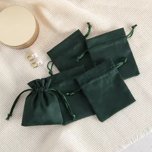 Dark green velvet jewelry drawstring pouch gift bag for small accessories necklace storage.
