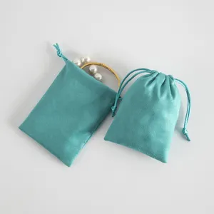 Teal velvet drawstring jewelry pouch detail, soft pouch for small accessories and storage.