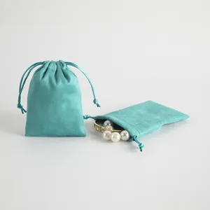 Turquoise velvet drawstring pouch detail, soft jewelry storage bag with pearls display.