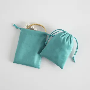 Cyan velvet drawstring pouch for jewelry packaging, soft gift storage bags with dual cords.