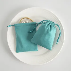 Teal velvet jewelry pouch drawstring storage bag for small accessories, rings and gifts.