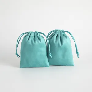 Turquoise velvet drawstring pouches for jewelry gifts and headphone storage display.
