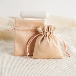 Soft beige velvet jewelry pouch with delicate drawstring, ideal for storing small items securely.